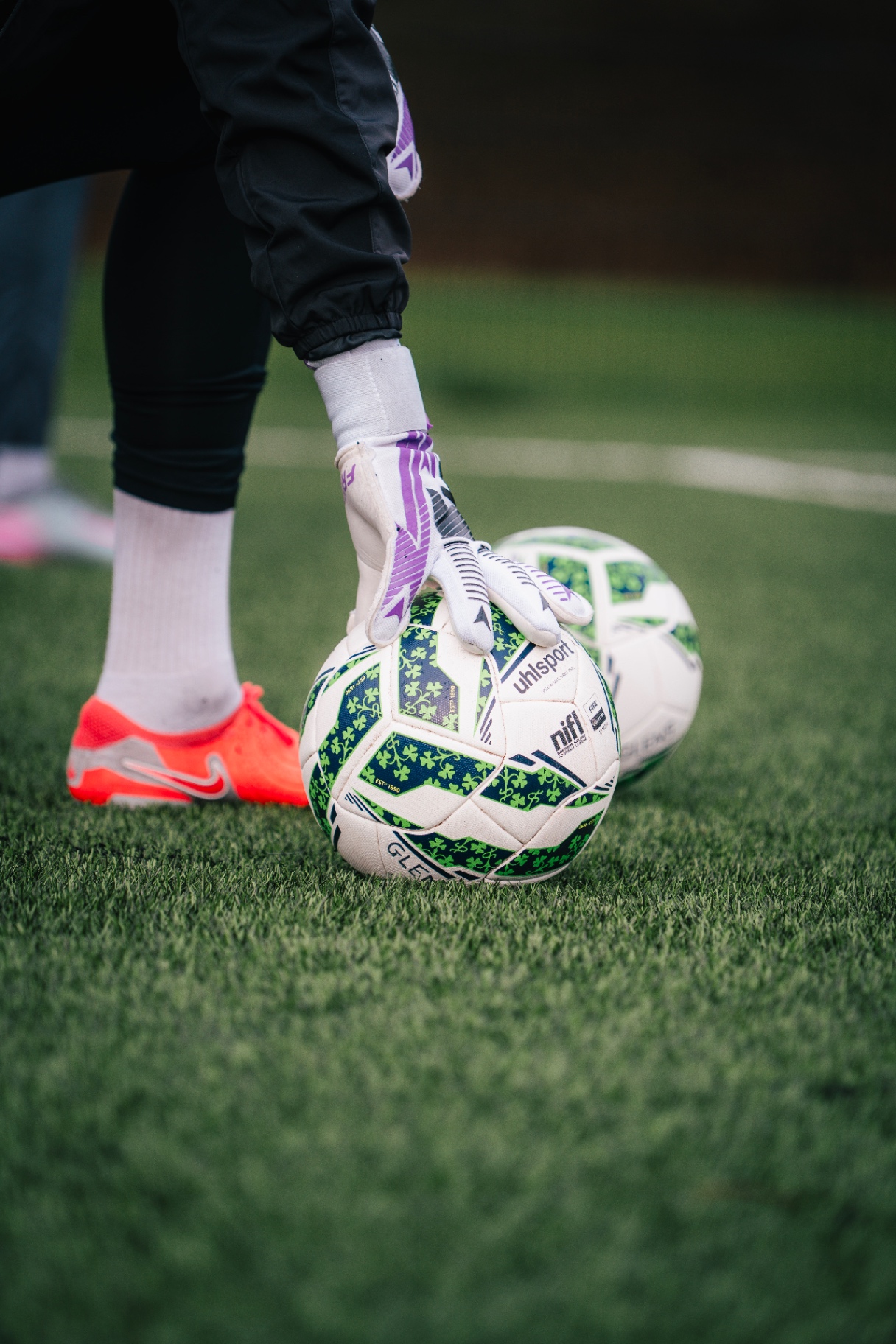 Goalkeeper placing a Northern Irish league matchball on the pitch