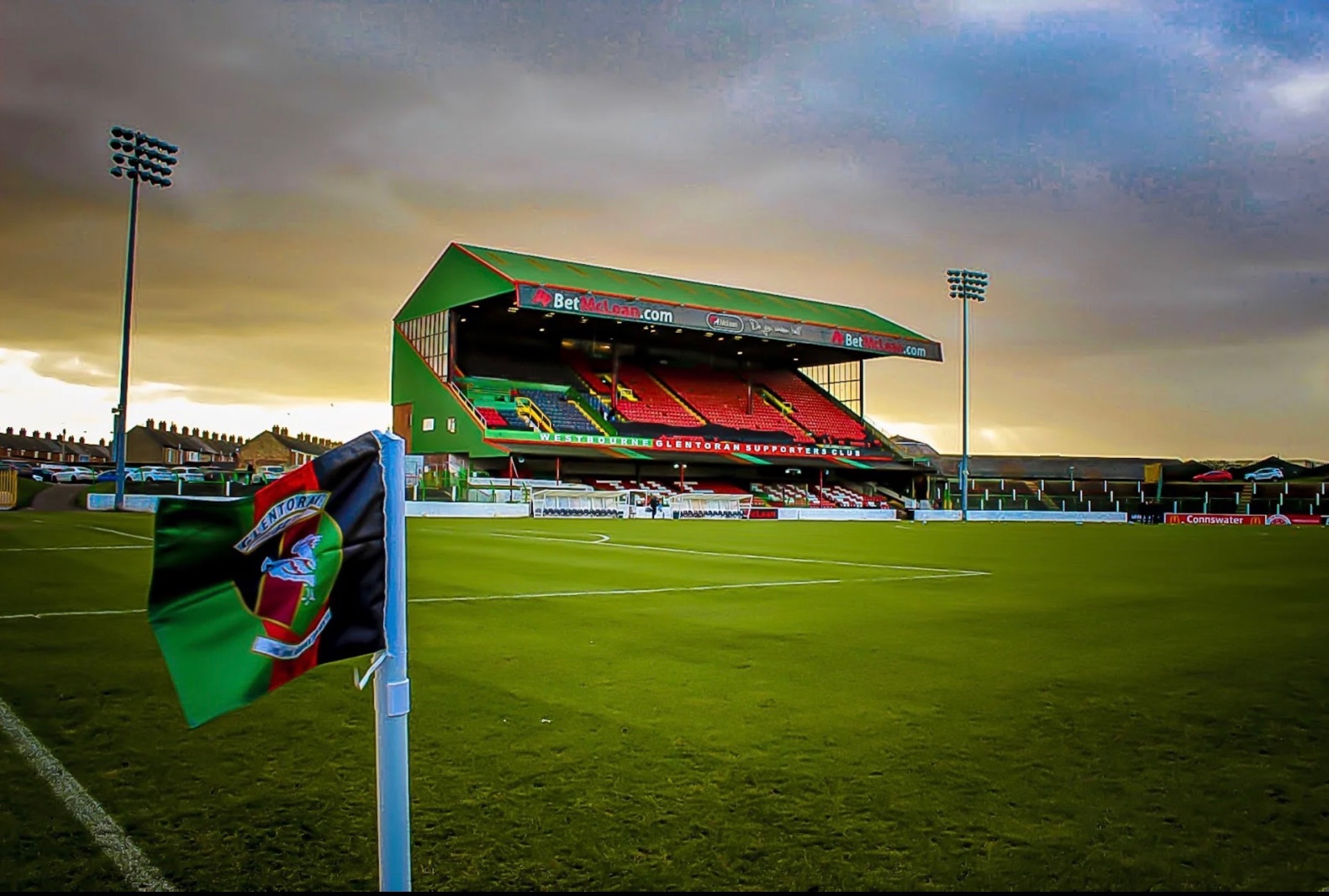 Corner flag and the main stand at The Oval, Glentoran FC's ground in Belfast, at sunset